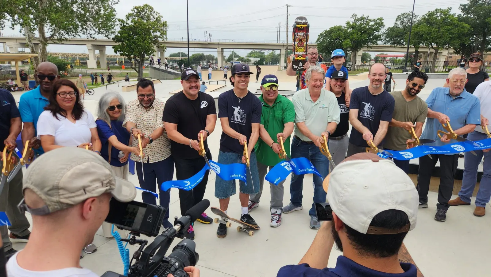 the moment the ribbon was officially cut, featuring the many elected officials and park board representatives who helped usher this project through the city