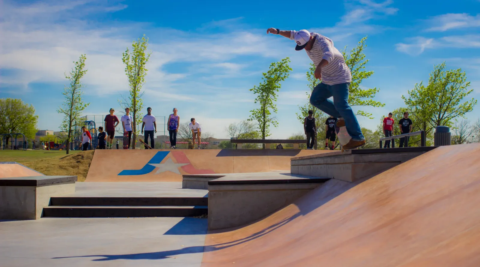 Arlington's Vandergriff Skatepark, with city branding and repurposed benches in the background. Before the park was built, skaters used these benches for tricks.