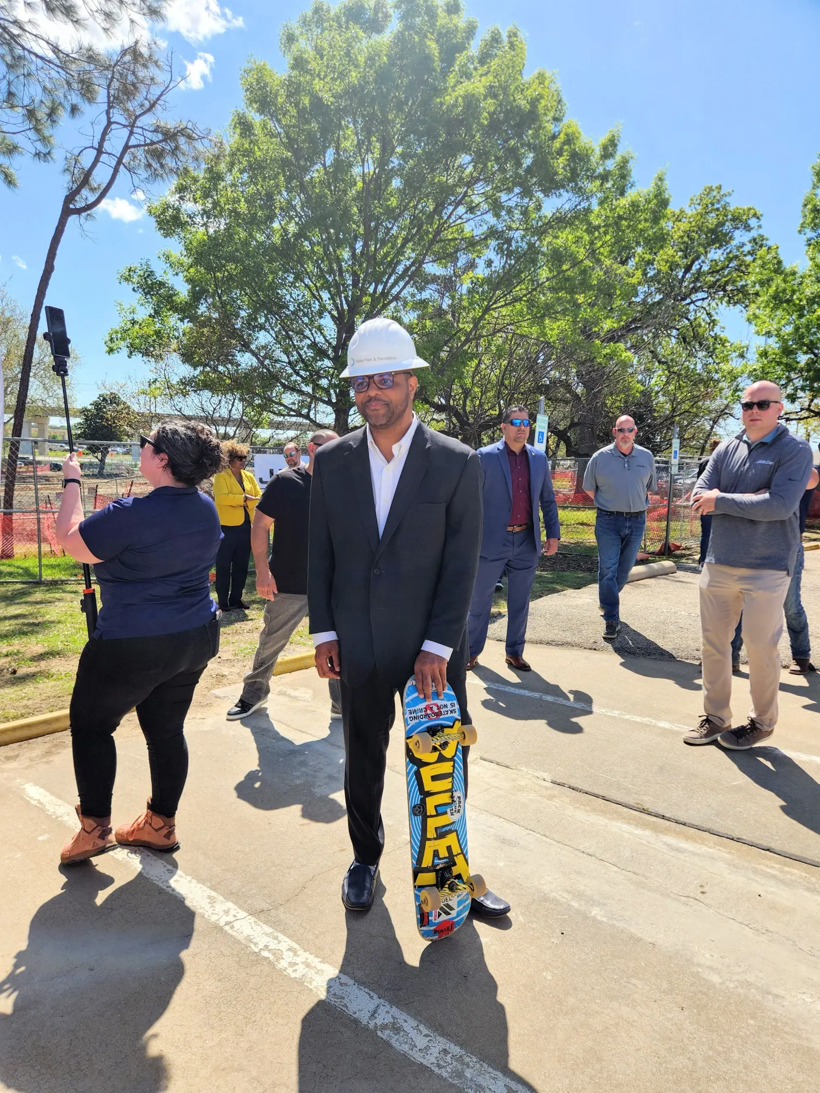 Bachman Lake Skatepark Ground Breaking Dallas Mayor Eric Johnson and a skateboard.jpg