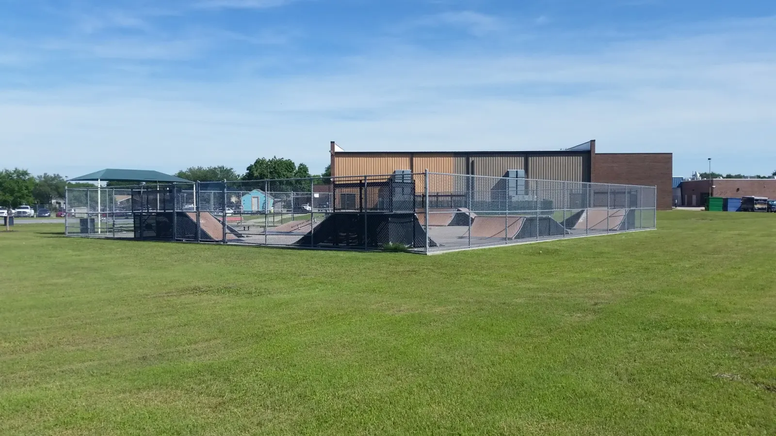 The chainlink fence makes for an uninviting space, and the modular ramps have a limited lifespan