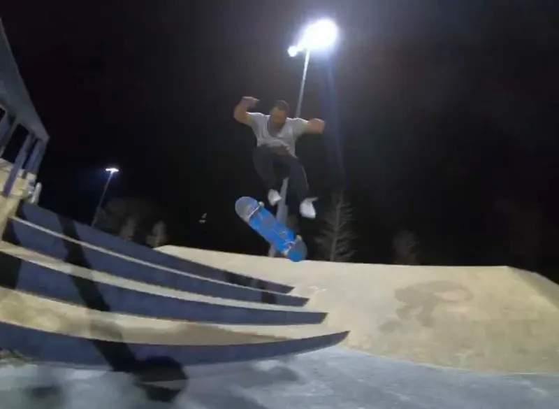 Jared skating under the park lights at dusk