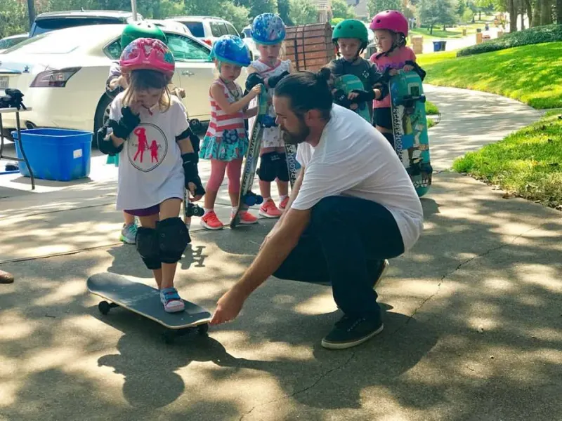 Josh helping a young skater get started on her board