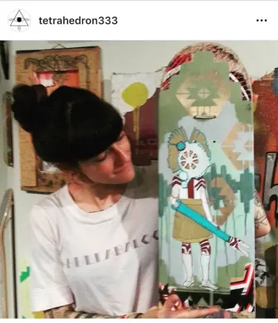 Kelly with donation skateboard